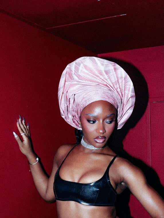 Ayra Starr in a pink gele styled by Gele Glamzzz