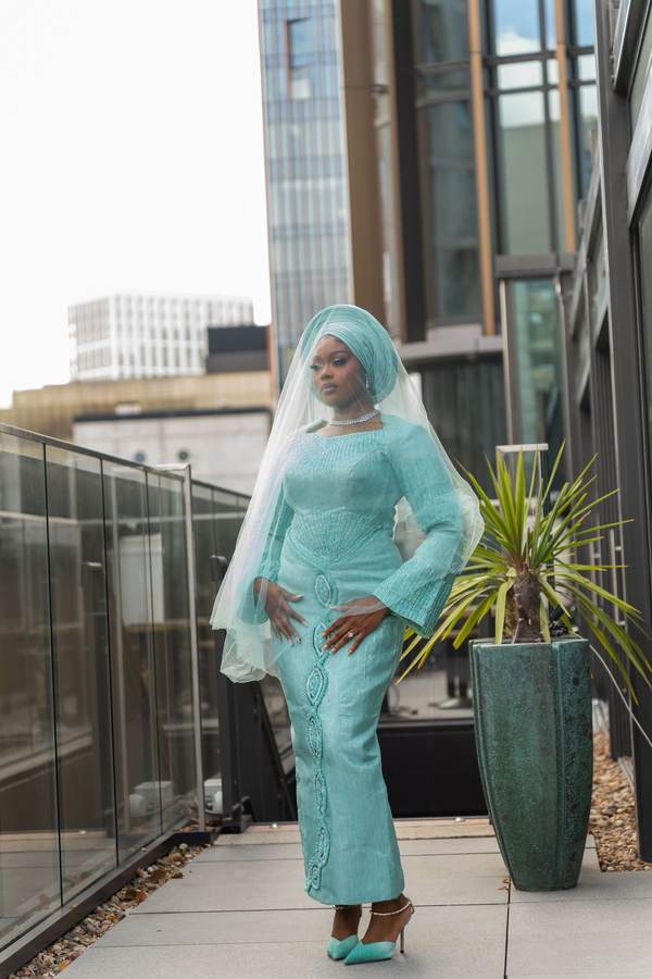 Client in a mint green traditional look with matching gele