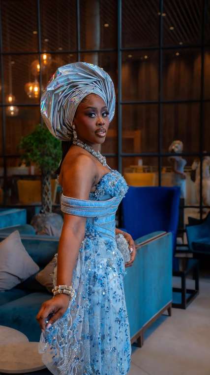 Client in a silver holographic gele and beaded pale blue gown