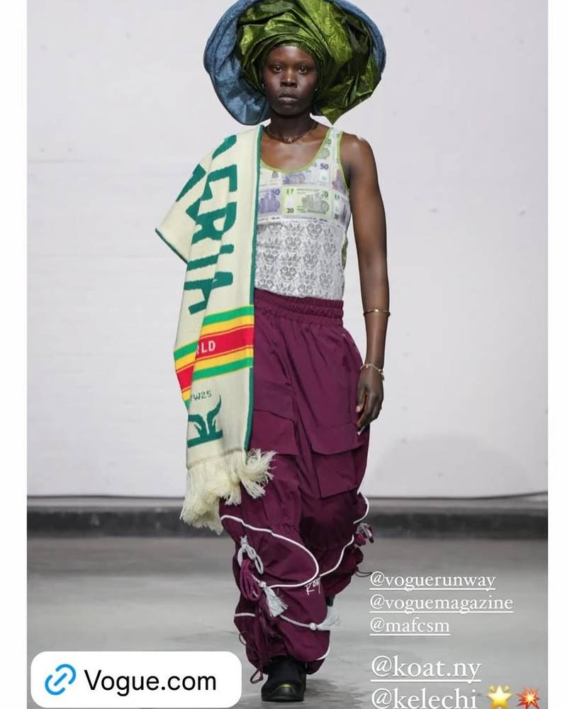 Runway model wearing a green and blue gele, Vogue-tagged fashion show feature